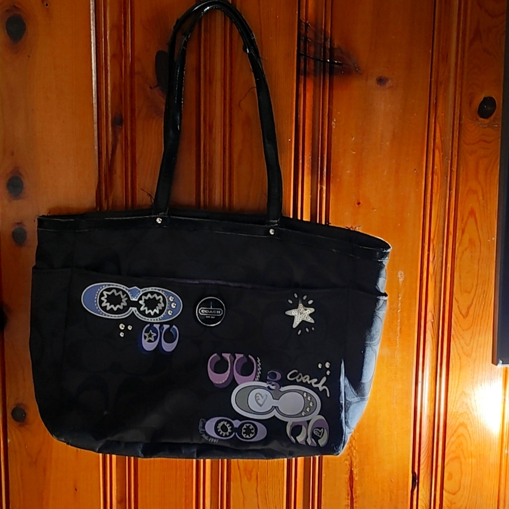 Coach black and purple beautiful diaper bag or messenger bag.